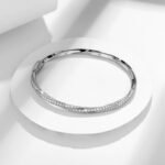 Elegant sterling silver bangle with dual rows of small diamonds.